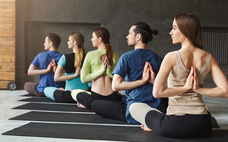 Group of women doing yoga in a modernly designed studio 